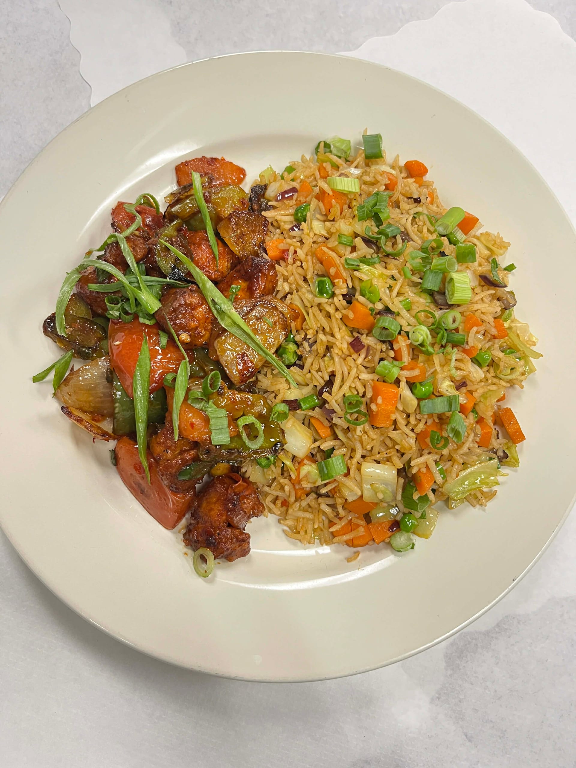 Fragrant fried rice stir-fried with mixed vegetables and soy sauce.